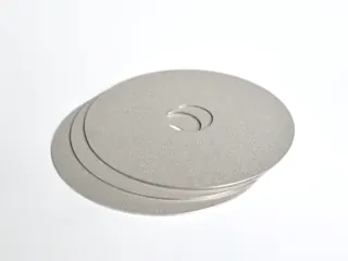 Sintered porous metal disc with center hole