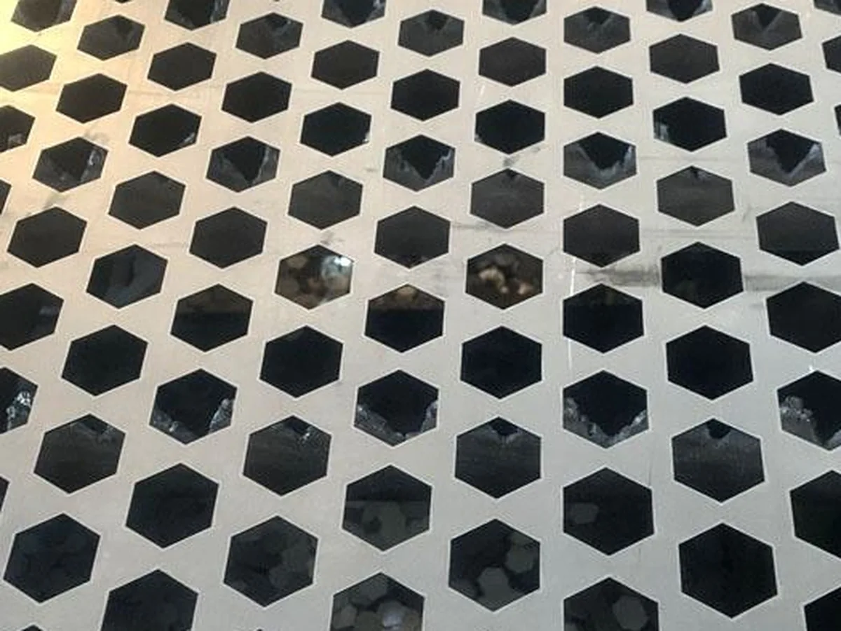 Titanium perforated sheet, hexagonal holes close-up